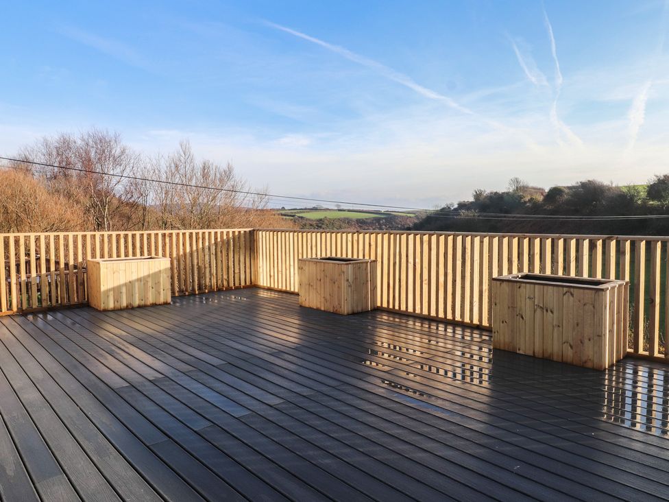 A deck area with wooden planters at The Hideaway