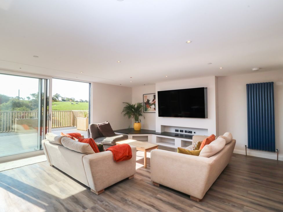 A living room with a sofa and television at The Hideaway in Mynytho near Abersoch