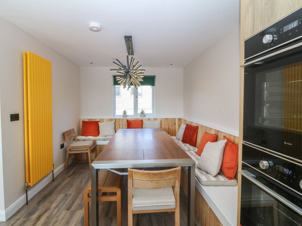 A dining room with a table and chairs at The Hideaway in Mynytho near Abersoch