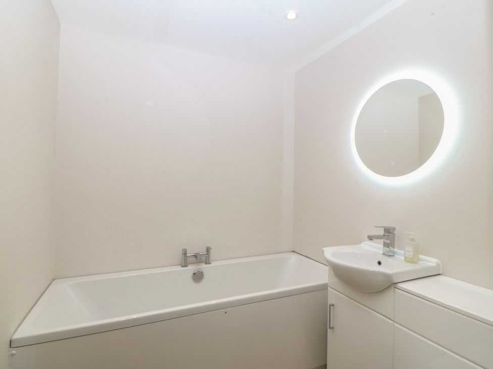 A bathroom with a bathtub and sink at The Hideaway in Mynytho near Abersoch