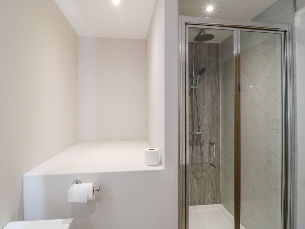 A bathroom with a shower and a toilet at The Hideaway in Mynytho near Abersoch