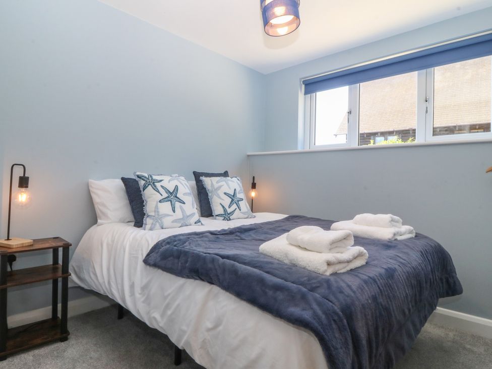 A bedroom with a bed and bedside table at The Hideaway in Mynytho near Abersoch