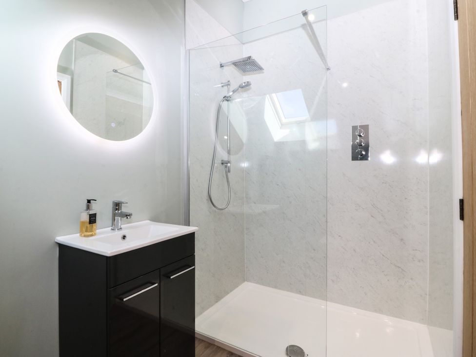 A bathroom with a shower and sink at The Hideaway in Mynytho near Abersoch