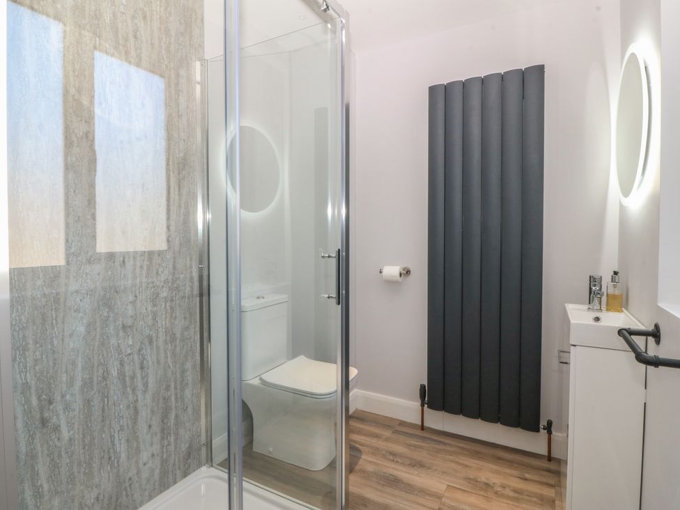 A bathroom with a shower and toilet at The Hideaway in Mynytho near Abersoch