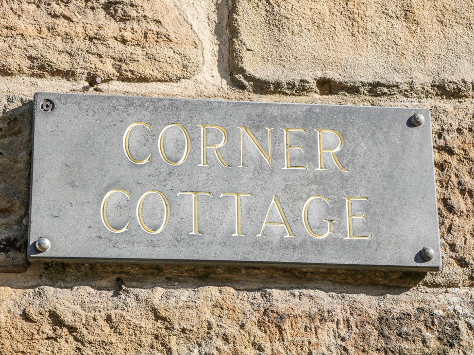 A nameplate reading Corner Cottage at Tideswell