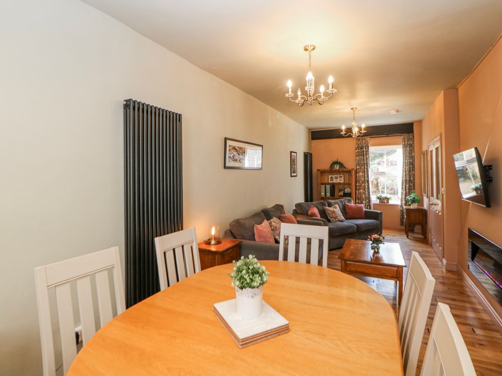 A dining room with a table and chairs at Corner Cottage in Tideswell