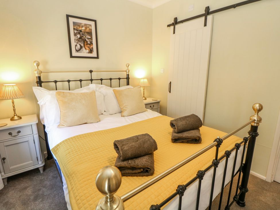 A bedroom with a double bed and bedside tables at Corner Cottage in Tideswell