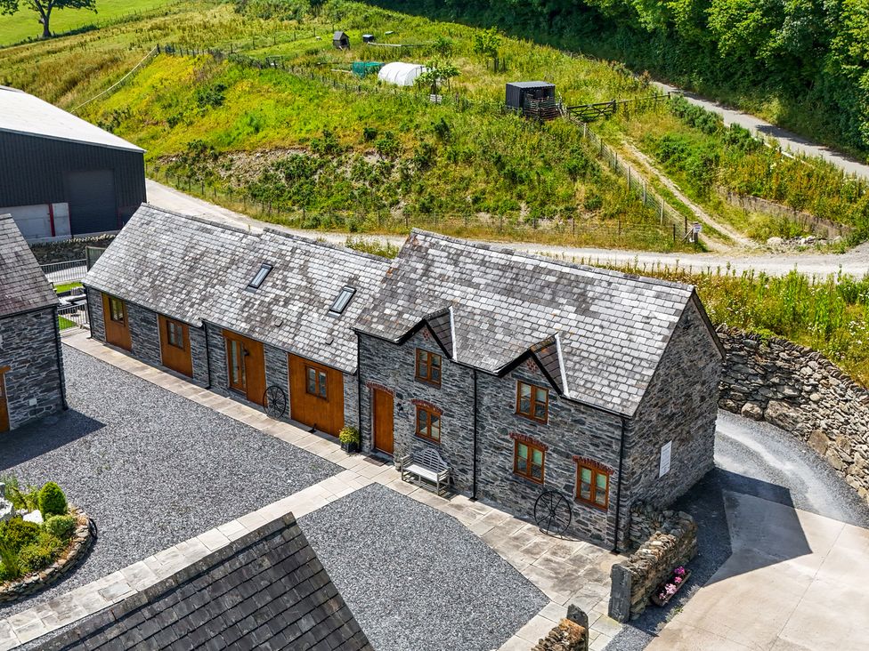A collection of buildings with a gravel area at Hay Store in Corwen