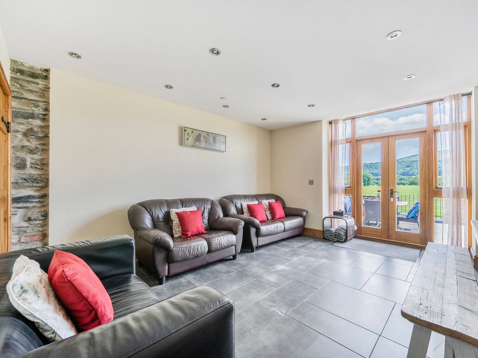A living room with sofas and a coffee table at Hay Store in Corwen