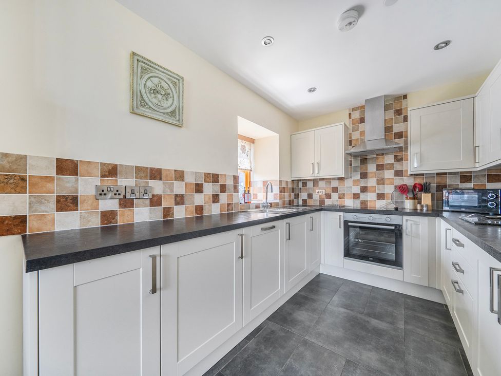 A kitchen with cabinets and an oven at Hay Store in Corwen