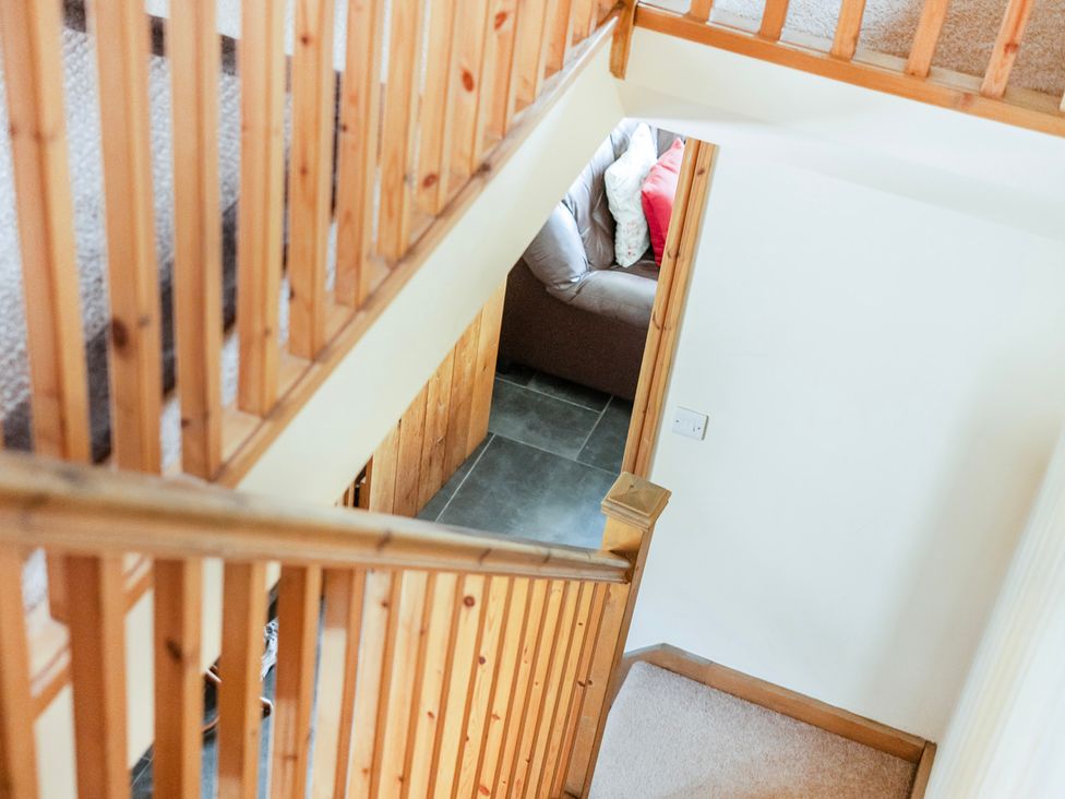A staircase with a view of a couch at Hay Store in Corwen