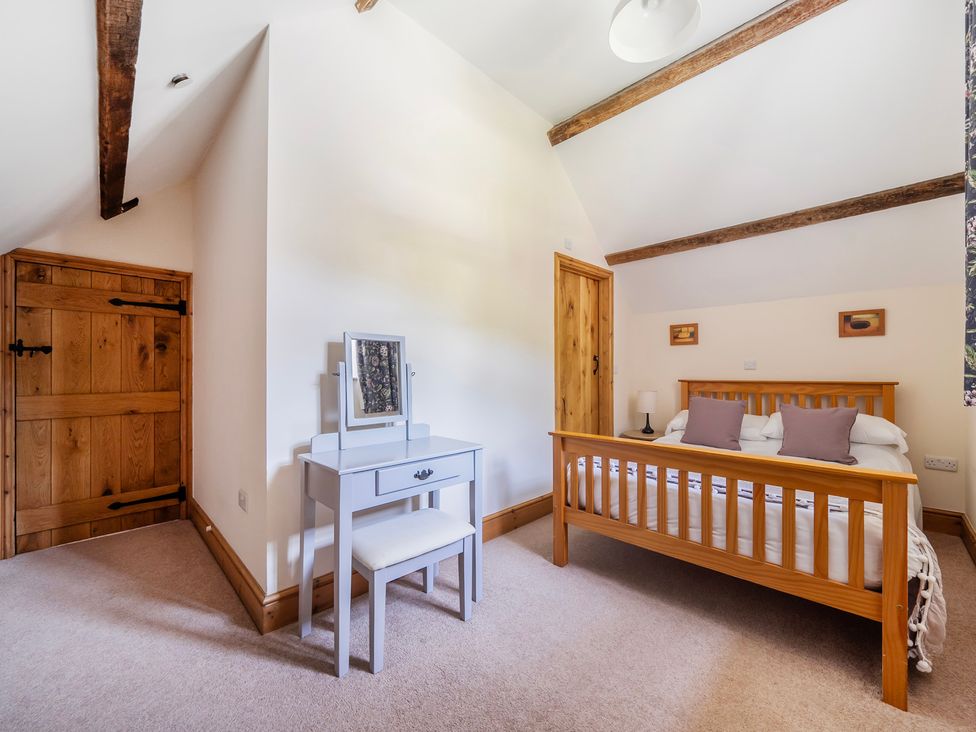 A bedroom with a bed and desk at Hay Store in Corwen