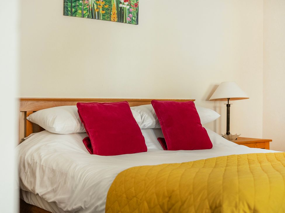 A bedroom with a bed and lamp at Hay Store in Corwen