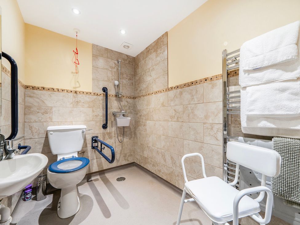 A bathroom with a toilet and sink at Hay Store in Corwen