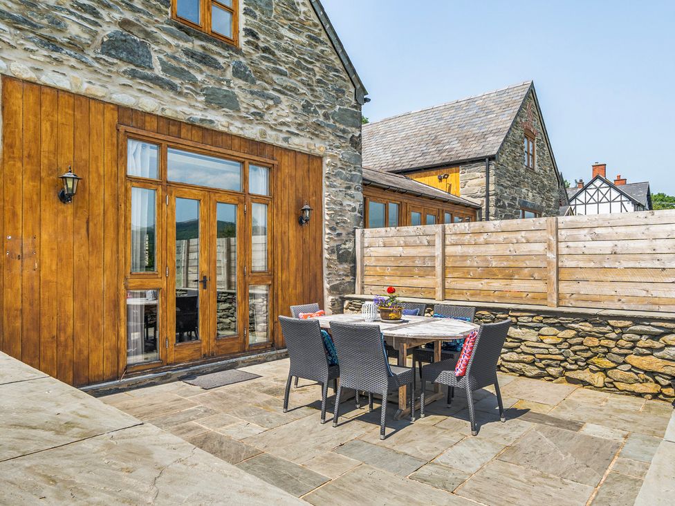 An outdoor patio area with a table and chairs at Hay Store in Corwen