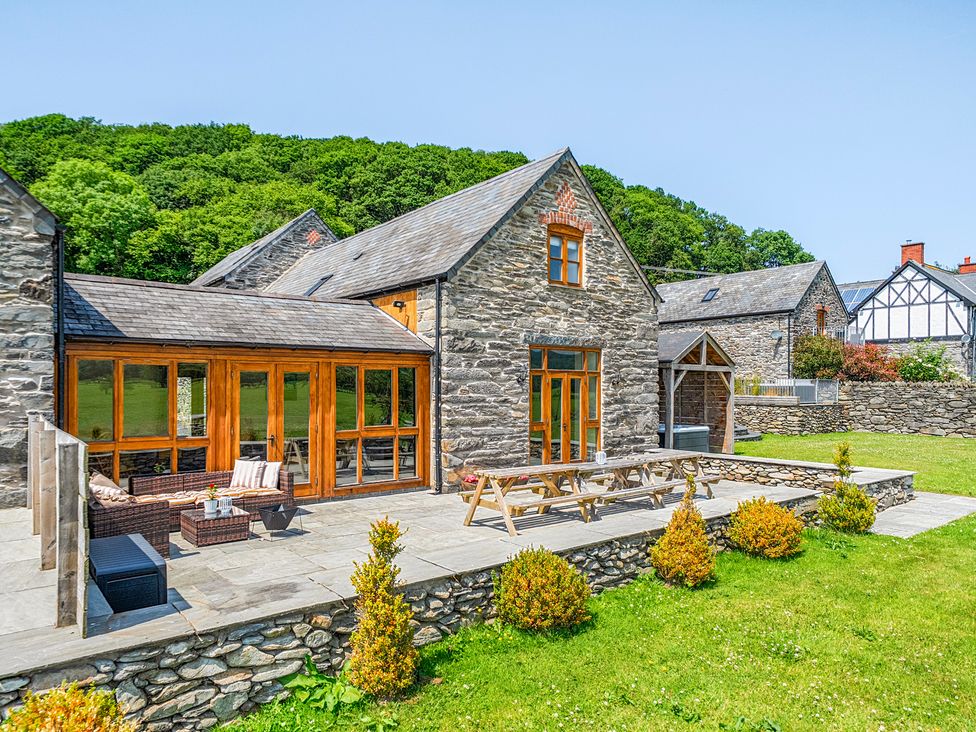 An outdoor space with a house and patio furniture at The Barn in Corwen