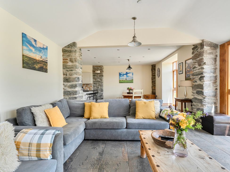 A living room with a sofa and coffee table at The Barn in Corwen