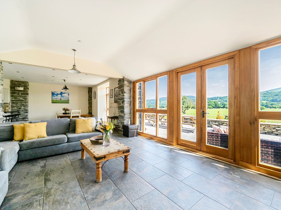 A living room with a sofa and coffee table at The Barn in Corwen