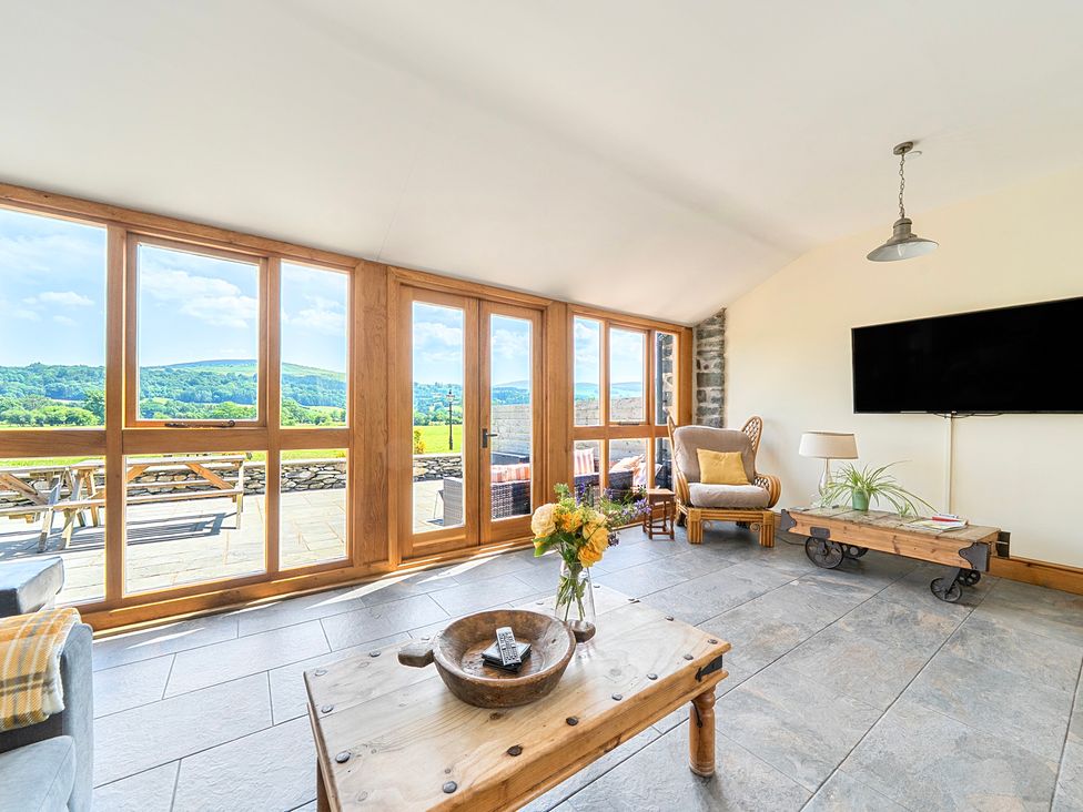 A living room with a view and a coffee table at The Barn in Corwen