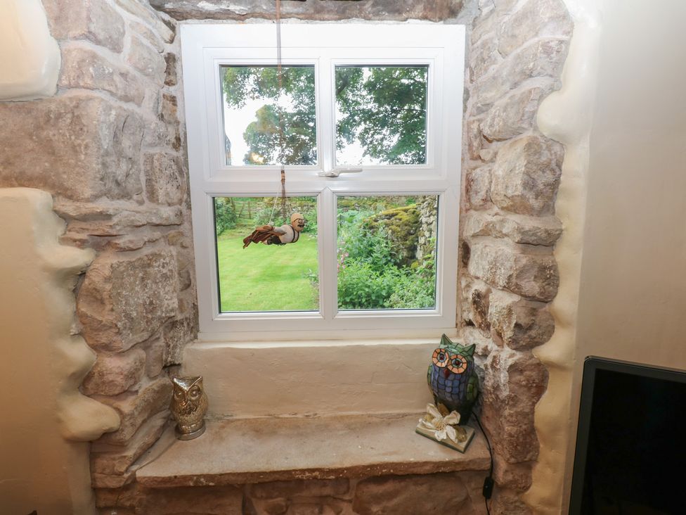 A window with stone wall and owl figurines at The LA'AL Cragg in Kirkby Stephen