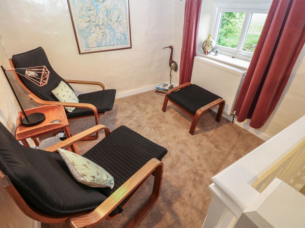 A snug with armchairs and footstools at The LA'AL Cragg in Kirkby Stephen