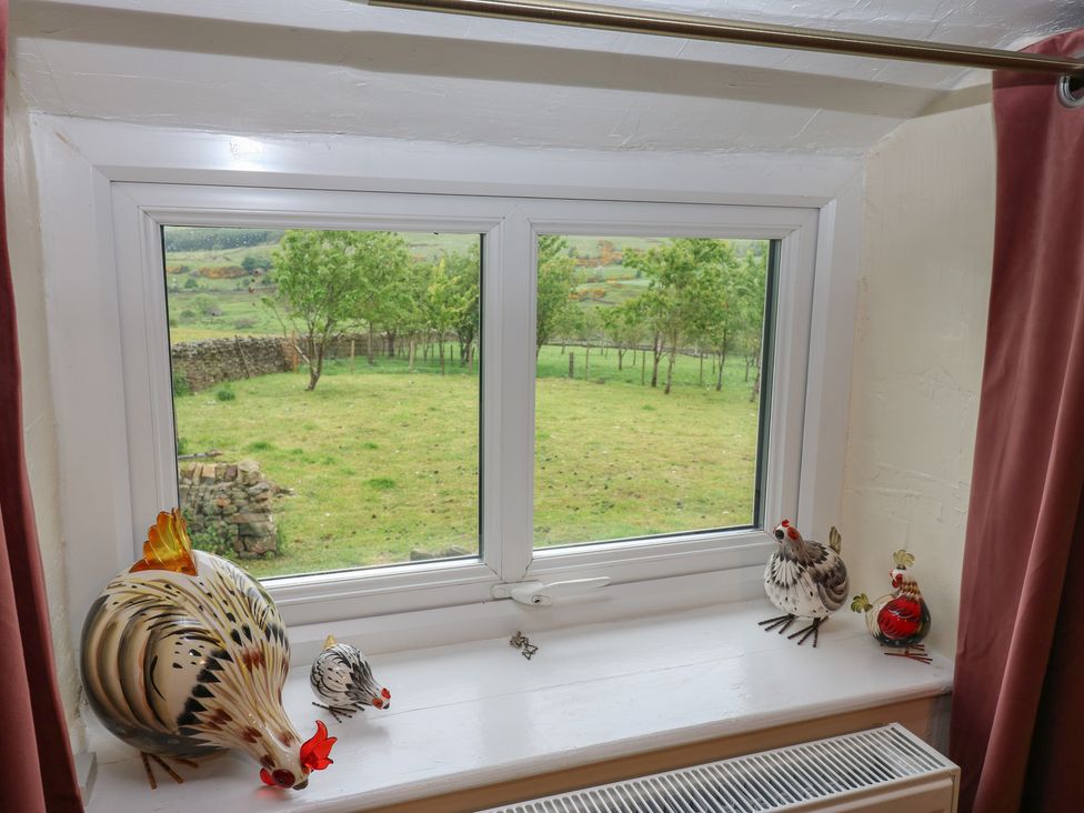 A window with decorative chickens and radiator at The LA'AL Cragg in Kirkby Stephen