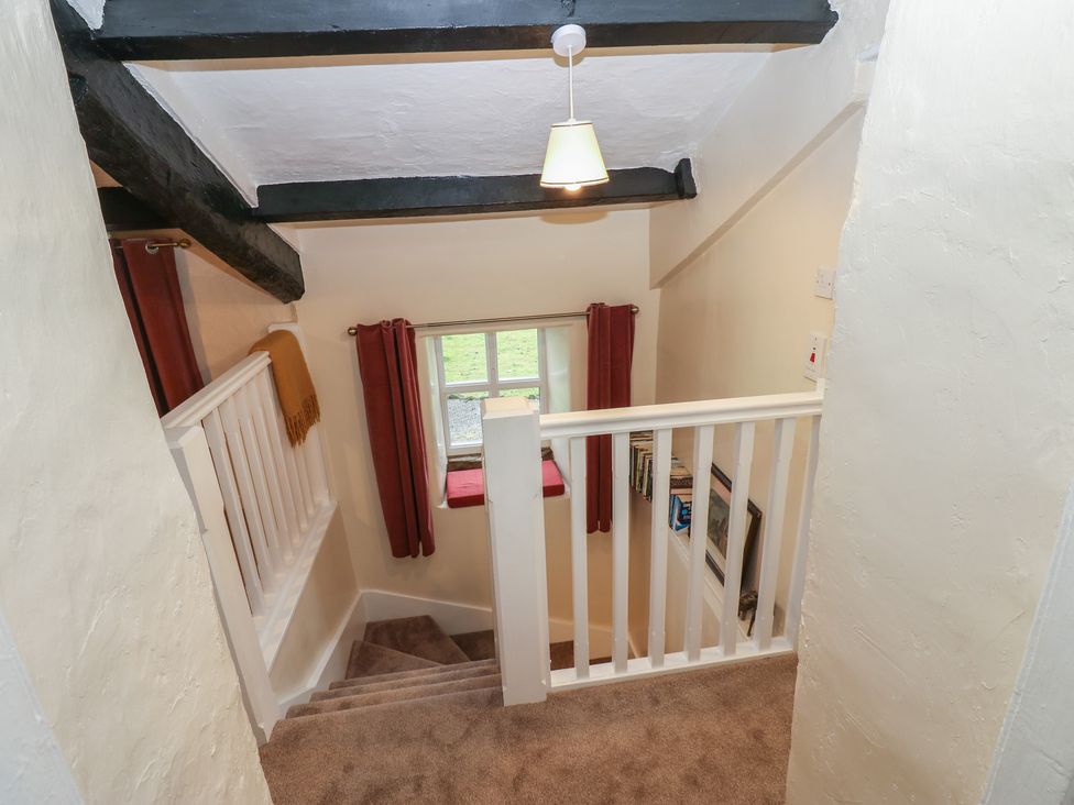 A staircase with a handrail and a window at The LA'AL Cragg in Kirkby Stephen