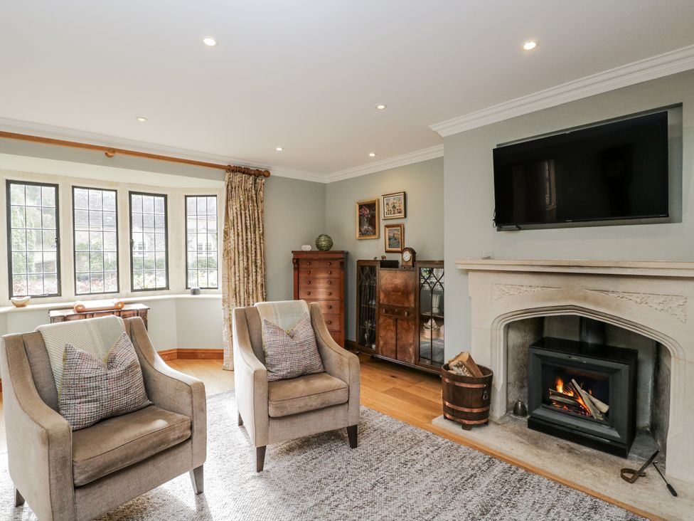 A living room with two chairs and a fireplace at The Old Hall in Tetbury