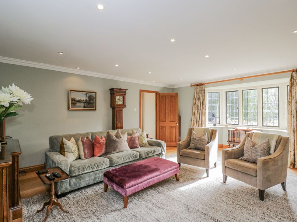 A living room with a sofa and armchairs at The Old Hall in Tetbury