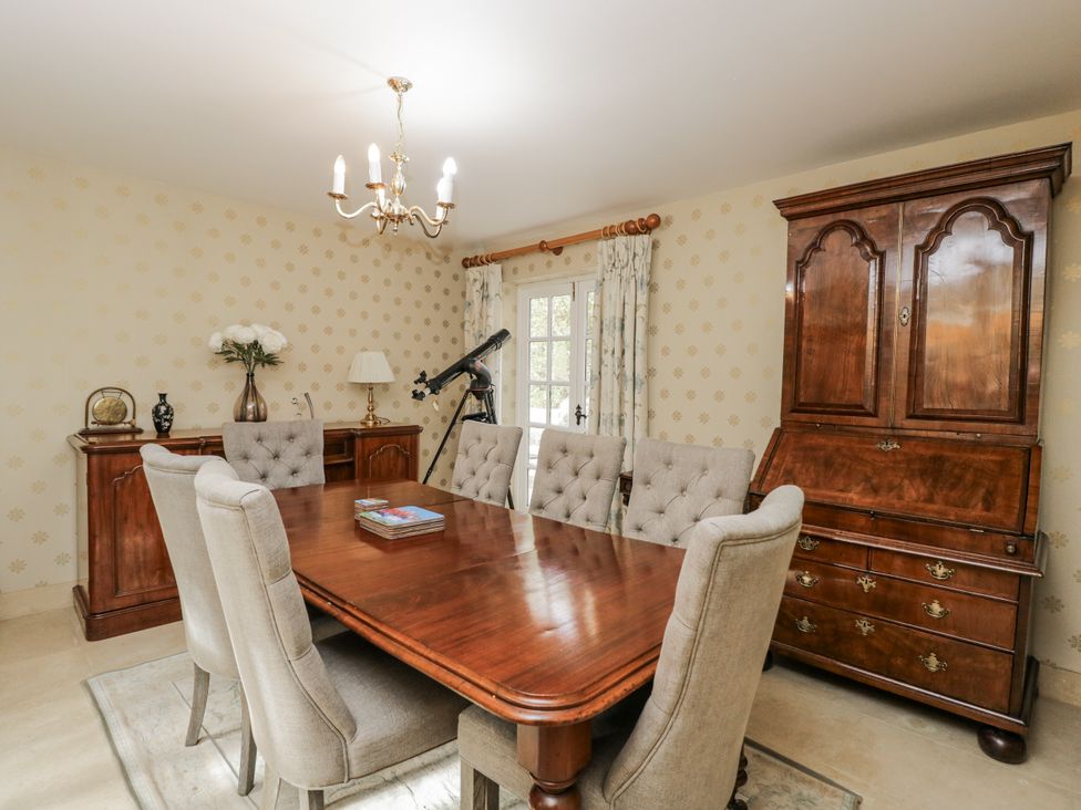 A dining room with a table and chairs at The Old Hall in Tetbury
