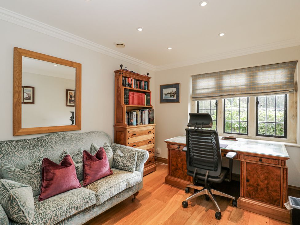 An office with a desk and bookshelf at The Old Hall in Tetbury