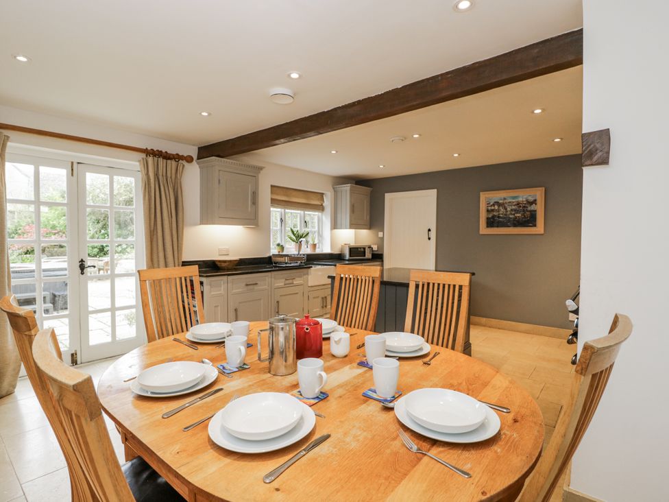 A kitchen with a wooden table and chairs at The Old Hall in Tetbury