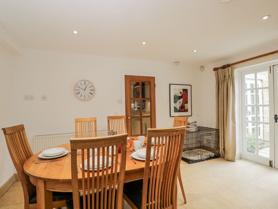 A dining room with a table and chairs at The Old Hall in Tetbury