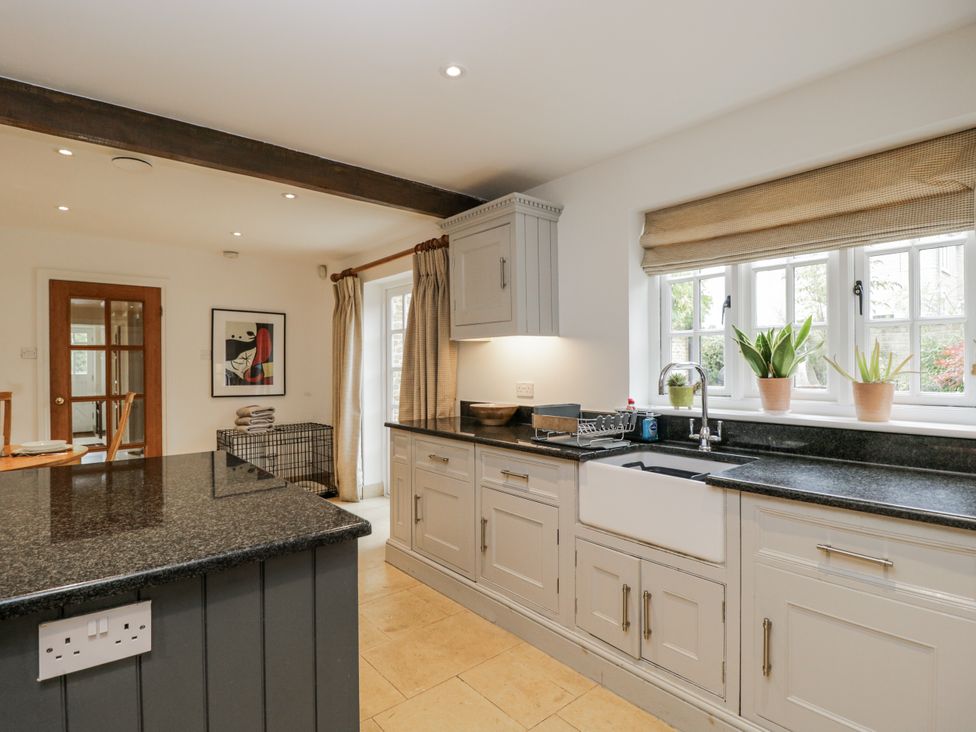 A kitchen with a sink and cooking surface at The Old Hall in Tetbury