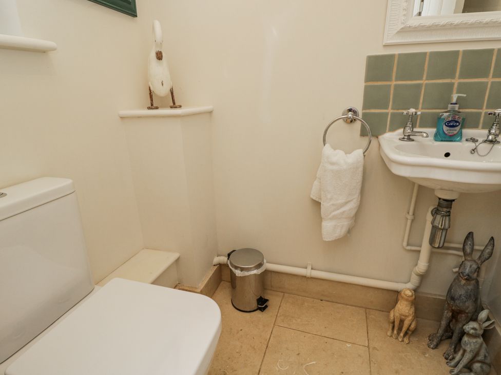 A bathroom with a toilet and sink at The Old Hall in Tetbury