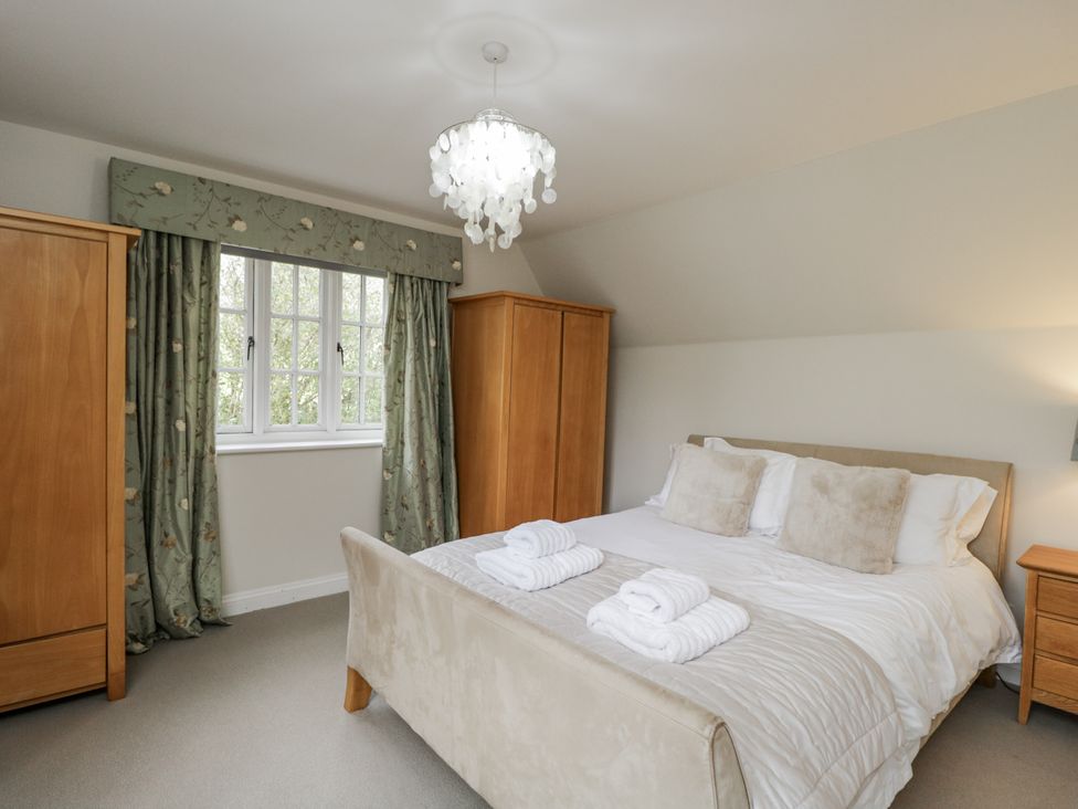 A bedroom with a bed and wardrobes at The Old Hall in Tetbury