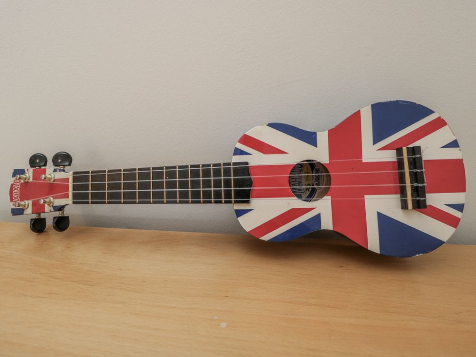 A ukulele with Union Jack design on a wooden surface at The Old Hall in Tetbury