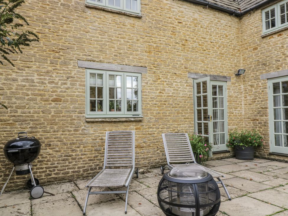 An outdoor area with a table and chairs at The Old Hall in Tetbury
