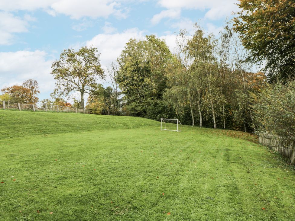 An outdoor area with a goalpost and trees at The Old Hall in Tetbury