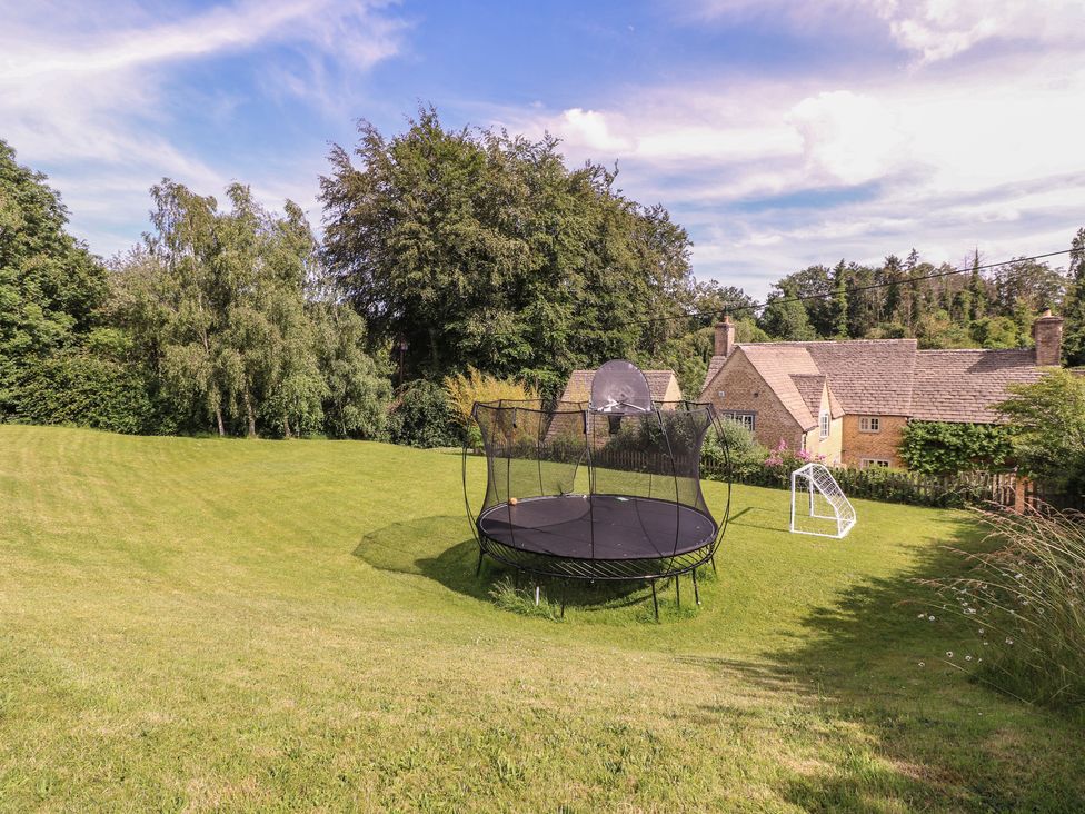 An outdoor area with a trampoline and soccer goal at The Old Hall Westonbit Nr Tetbury