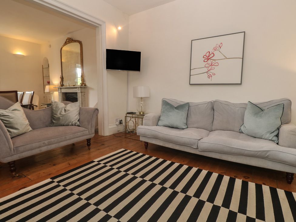 A living room with a sofa and armchair at Scillonia in Penzance