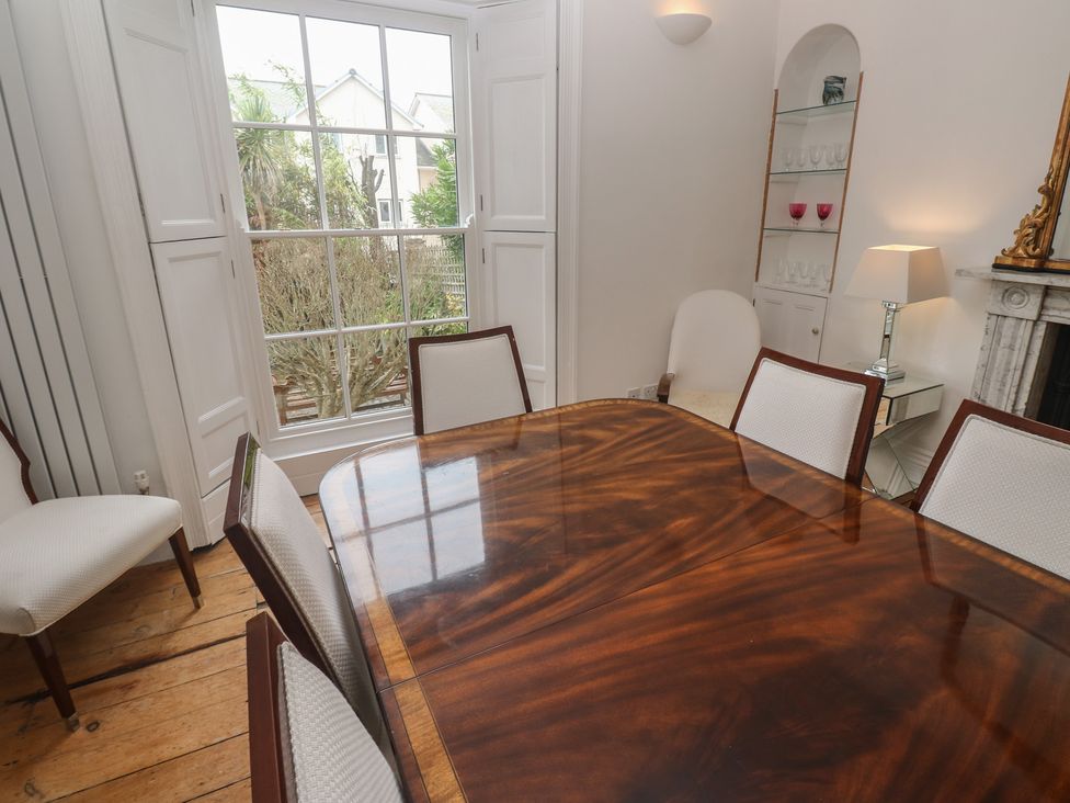 A dining room with a table and chairs at Scillonia in Penzance