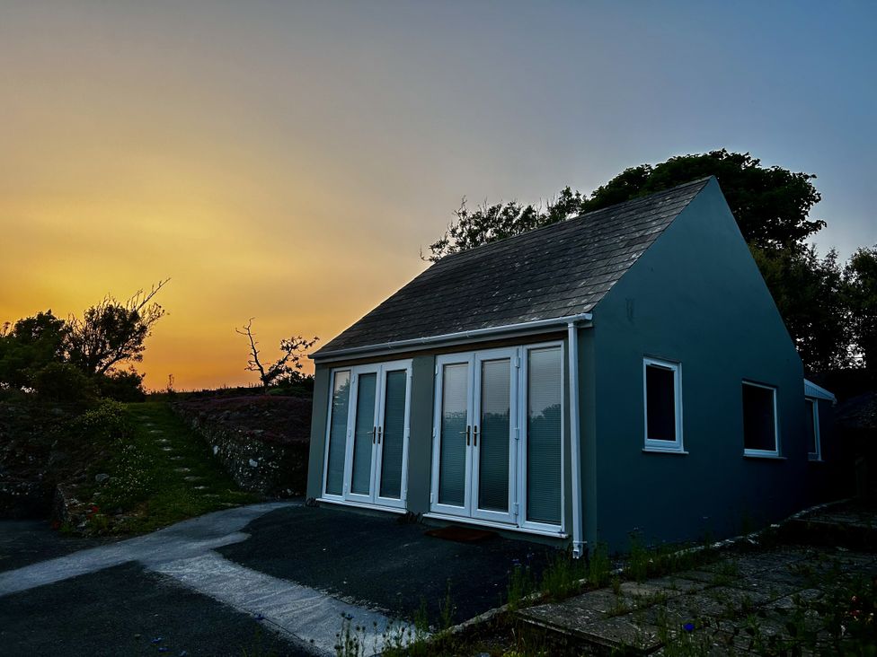 A house with large windows and a pathway at Tower Cottage Near Pembroke