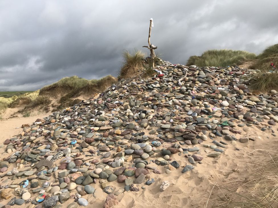 A pile of stones with driftwood at Tower Cottage Near Pembroke