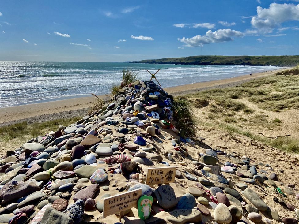 A pile of decorated stones at a beach near the ocean at Tower Cottage near Pembroke