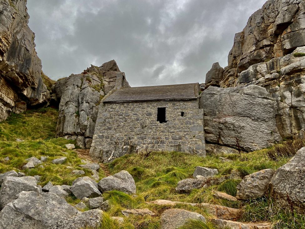A stone building surrounded by rocks at Tower Cottage Near Pembroke