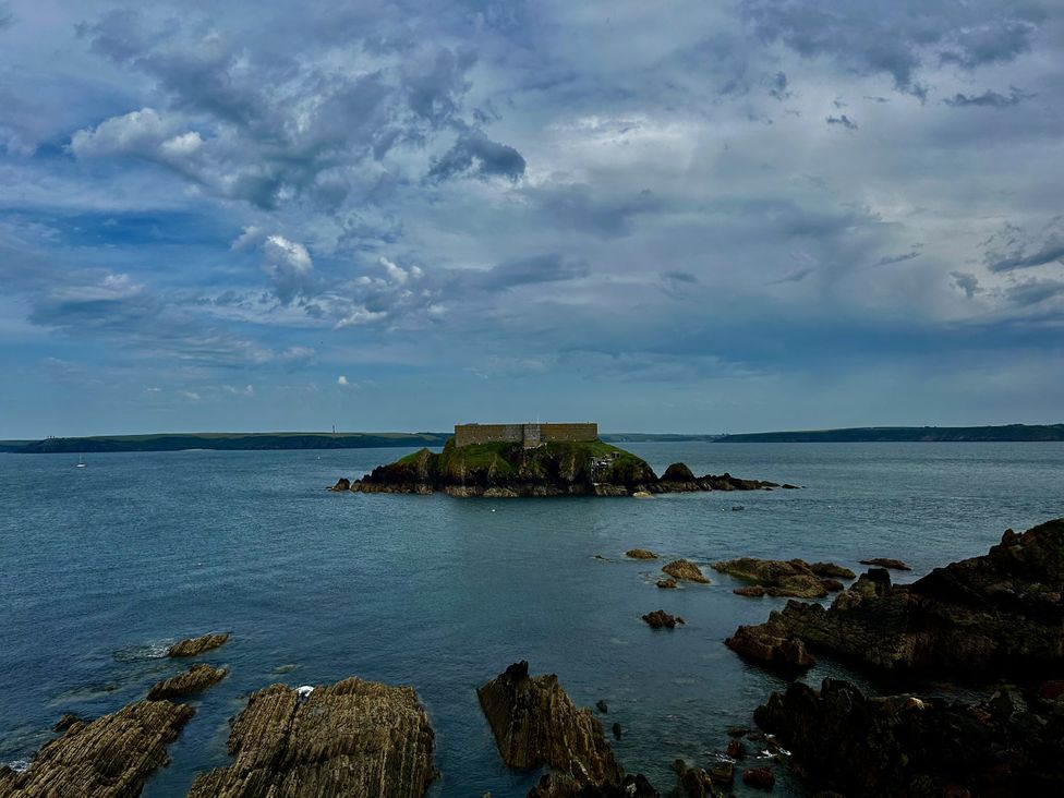 A view of an island with a fort surrounded by rocks at Tower Cottage near Pembroke