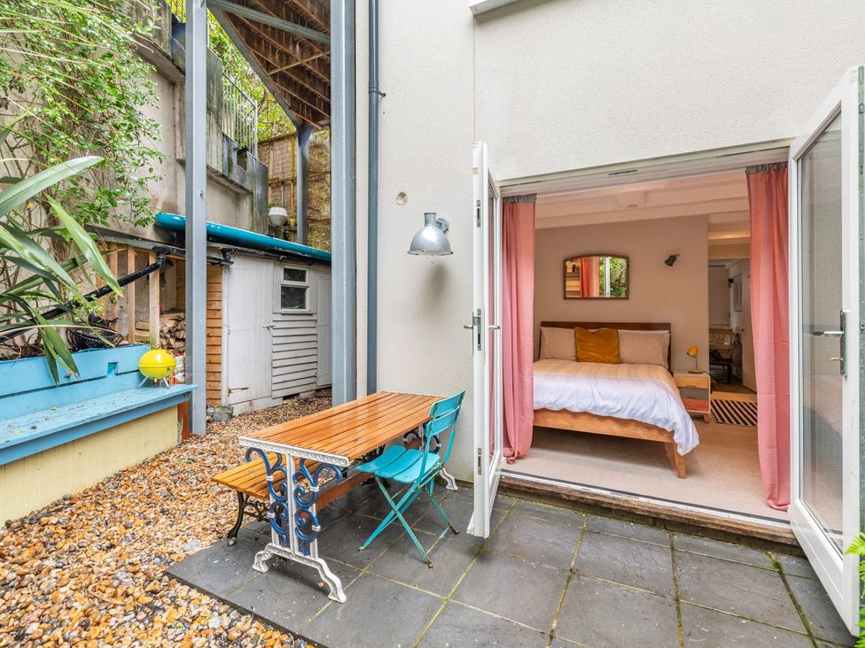 A bedroom with a bed and outdoor table at 14 Marine Parade, Lyme Regis