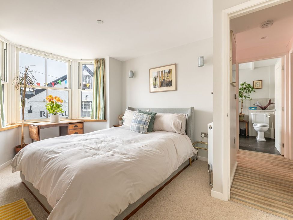 A bedroom with a bed and a desk at 14 Marine Parade in Lyme Regis