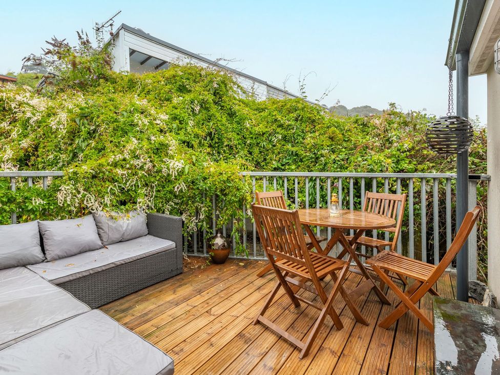 A balcony with a dining table and outdoor sofa at 14 Marine Parade Lyme Regis
